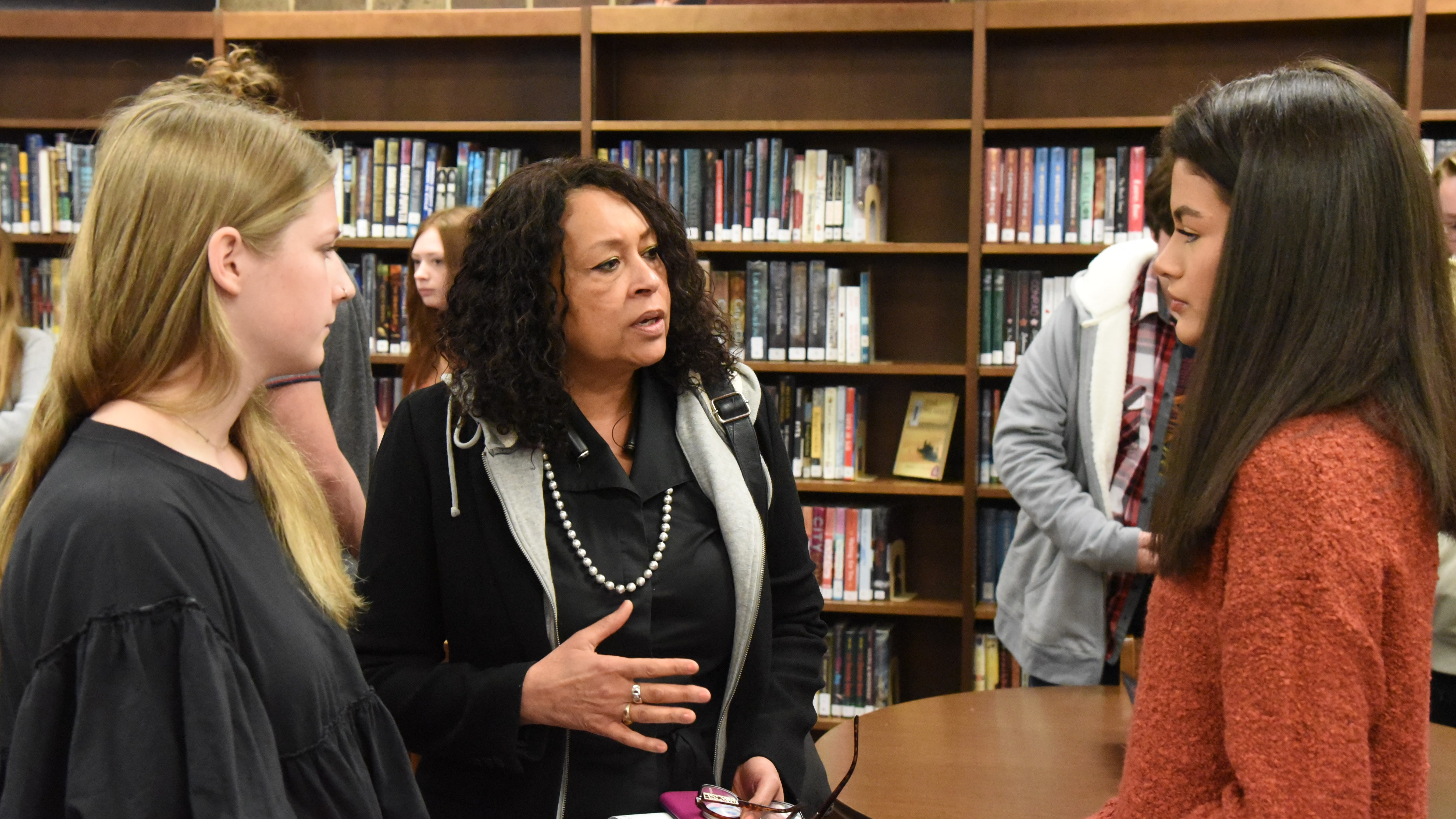 Dawn Michelle Foster, Redevelopment Director for the City of Knoxville, speaks with Central High students Lily Ewers (left) and Elena Karsten about their group’s plan for “Crossroads Park. 
